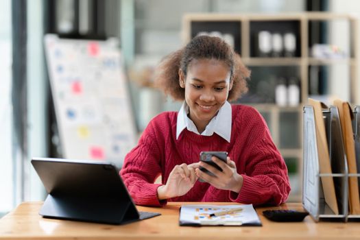 Portrait of Happy black woman reading phone message.