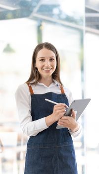 Portrait of a Bright smiling woman prepares to open a shop to welcome customers The owner of the coffee shop