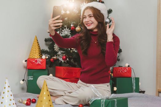 Cheerful lady surprised of the present after the opening in the gift box. Marry Christmas and Happy Holidays and New Year eve celebrating concept.
