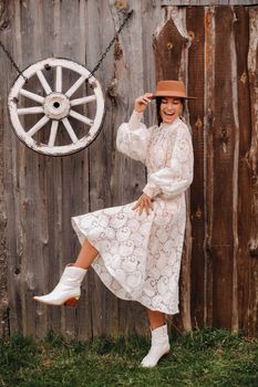 Beautiful girl in vintage lace dress and hat at the ranch.