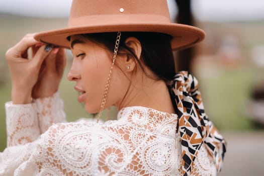 Beautiful girl in vintage lace dress and hat at the ranch.