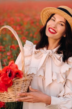 A girl in a white dress and with a basket of poppies walks through a poppy field.