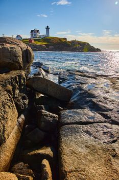 Image of Detail of rocky Maine coasts with lighthouse in background