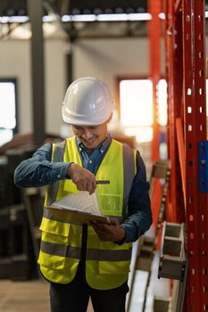 Working at warehouse. Male warehouse worker checking in storage department. Employee organizing goods distribution to the market