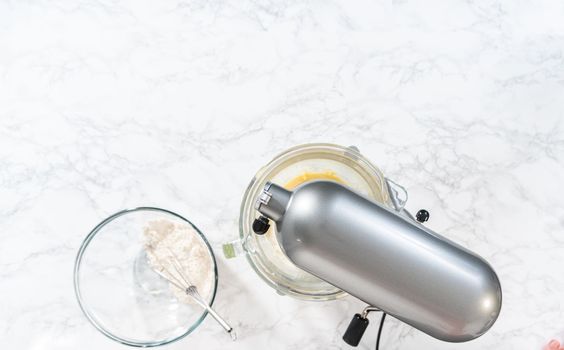 Flat lay. Mixing ingredients in kitchen electric mixer to bake American flag mini cupcakes.