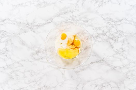 Flat lay. Mixing ingredients in a glass mixing bowl to bake a chocolate cupcake.