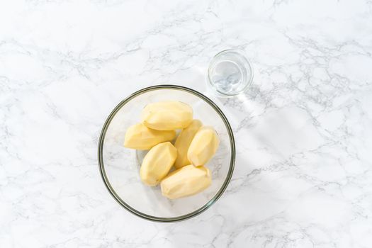 Flat lay. Mashed potatoes. Measured ingredients in glass mixing bowls to prepare mashed potatoes in a pressure cooker.