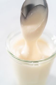 Cream cheese glaze in small glass jat.