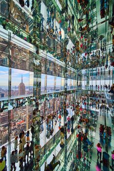 Image of Huge skyscraper interior mirror reflections Summit One with New York City skyline and Empire State Building outside