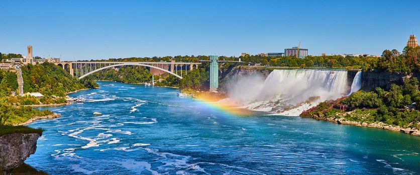 Image of Stunning rainbow over Niagara River looking at American Falls and Rainbow Bridge
