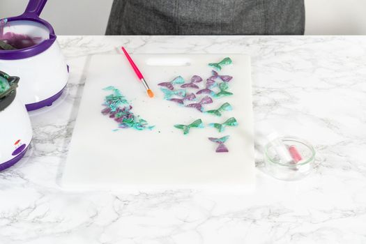 Removing chocolate mermaid tails from silicone molds.