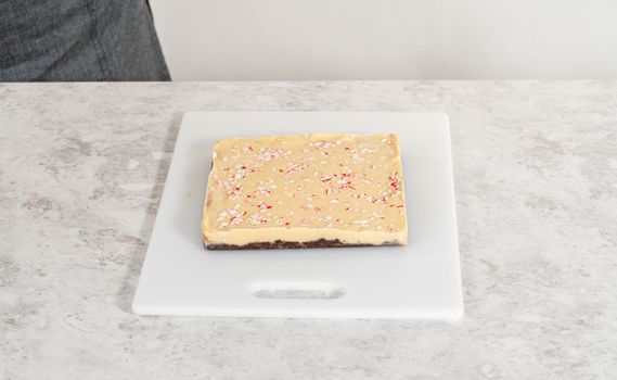 Scoring candy cane fudge into the reusable plastic bag.