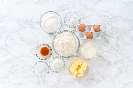 Flat lay. Measured ingredients in glass mixing bowls to bake American flag mini cupcakes.