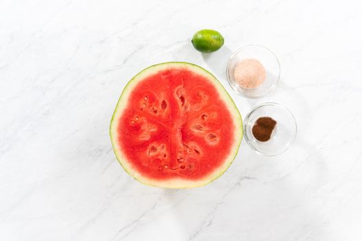 Flat lay. Measured ingredients in a small glass mixing bowl to prepare chili lime watermelon pops.