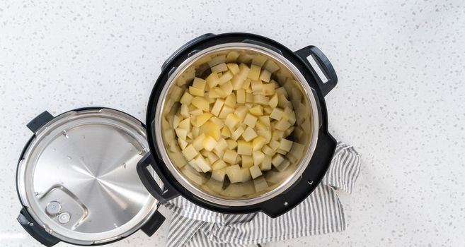 Flat lay. Cooking potatoes and eggs in a pressure cooker to make potato salad.
