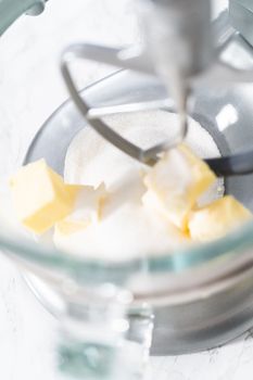 Mixing ingredients in kitchen electric mixer to bake American flag mini cupcakes.