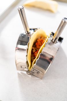 Flat lay. Filling empanada dough with turkey filling to make turkey empanadas.