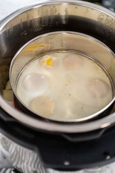 Cooking potatoes and eggs in a pressure cooker to make potato salad.