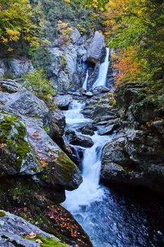 Image of Three tiers of waterfalls in Upstate New York through boulders with fall foliage