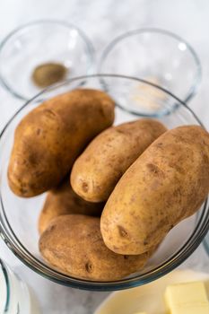 Mashed potatoes. Measured ingredients in glass mixing bowls to prepare mashed potatoes in a pressure cooker.