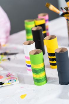 Making different bugs out of empty toilet paper rolls during homeschooling art class.