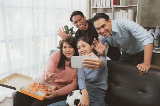Excited friends having fun by watching football or soccer match and eating pizza at home. Friendship, leisure, rest, home party football, Soccer concept.