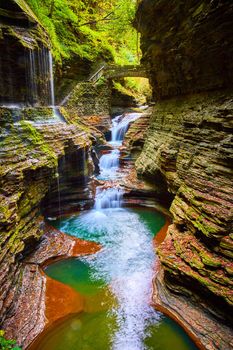 Image of Stone bridge and trail around and over stunning waterfall gorge with terraced rocks in Upstate New York