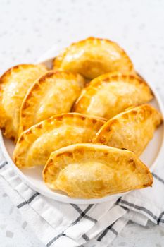 Freshly baked turkey empanadas on the kitchen counter.