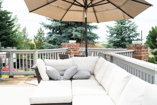 Patio of a luxury single-family home furnished with modern furniture.