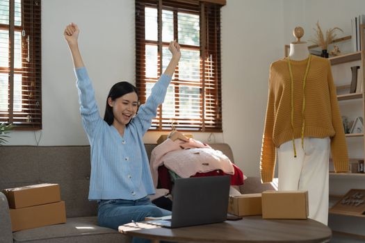 Young person using credit card and laptop computer. Online shopping, e-commerce concept.