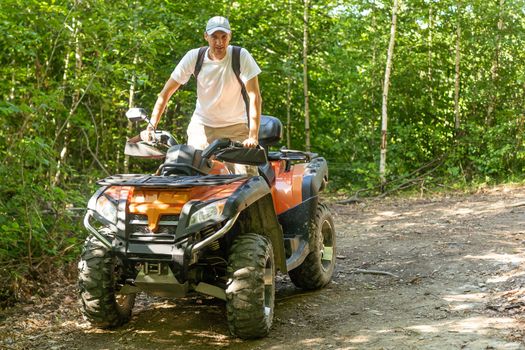 man quad bike in the forest.