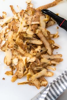 Peeling and cutting Russet potatoes to make potato salad.