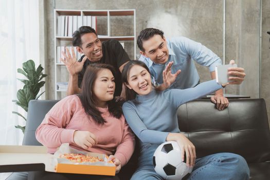 Excited friends having fun by watching football or soccer match and eating pizza at home. Friendship, leisure, rest, home party football, Soccer concept.