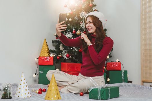 Cheerful lady surprised of the present after the opening in the gift box. Marry Christmas and Happy Holidays and New Year eve celebrating concept.