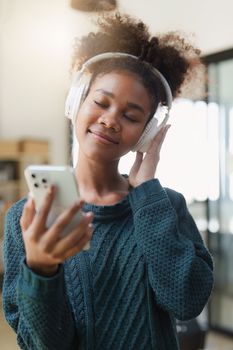 Young Black Woman Listening To Music Online Wearing Wireless Earphones, Enjoying Favorite Song. Playlist, Music Application.