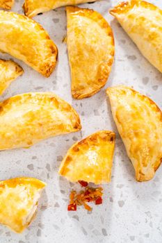 Freshly baked turkey empanadas on the kitchen counter.