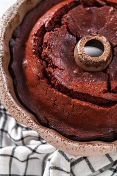 Cooling freshly baked red velvet bundt cake on a kitchen counter.