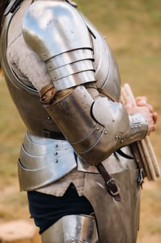 Close-up of a medieval knight in armor preparing for battle.