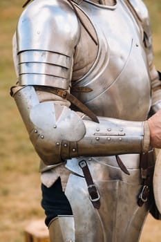 Close-up of a medieval knight in armor preparing for battle.