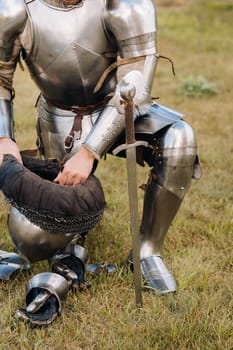 Close-up of a medieval knight in armor preparing for battle.