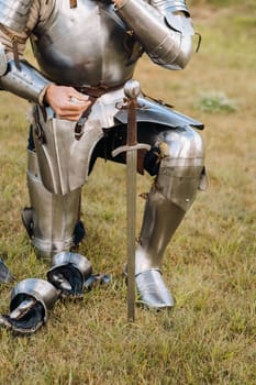 Close-up of a medieval knight in armor preparing for battle.