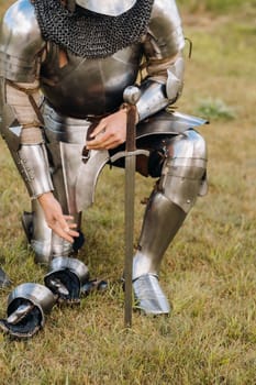 Close-up of a medieval knight in armor preparing for battle.