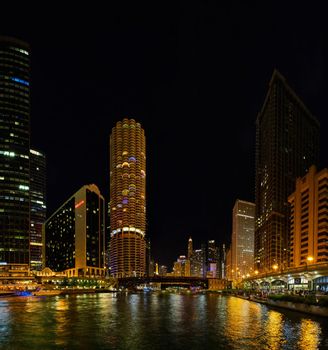 Image of Chicago canals at night with skyscrapers lit up