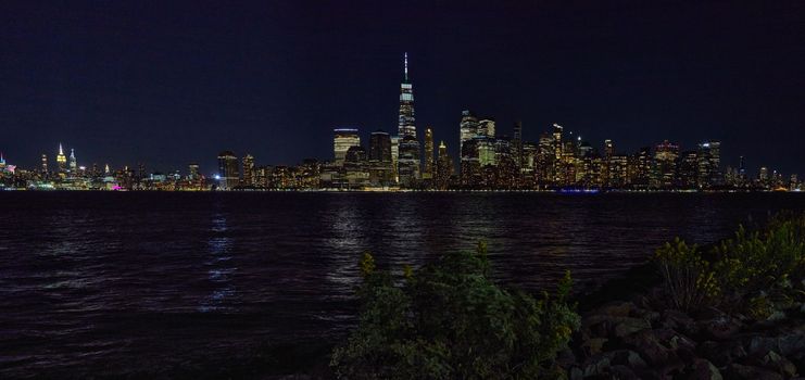 Image of Full wide panoramic New York City skyline at night from New Jersey with city lights