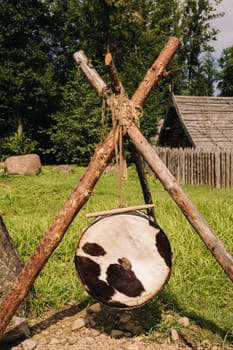 An old traditional drum with fur hanging in a medieval village.