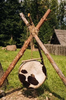 An old traditional drum with fur hanging in a medieval village.