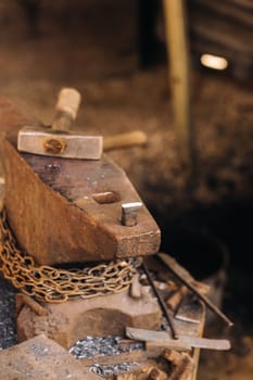 Forge, hammer on an anvil standing on the street.