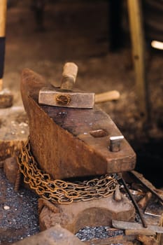 Forge, hammer on an anvil standing on the street.