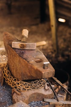 Forge, hammer on an anvil standing on the street.