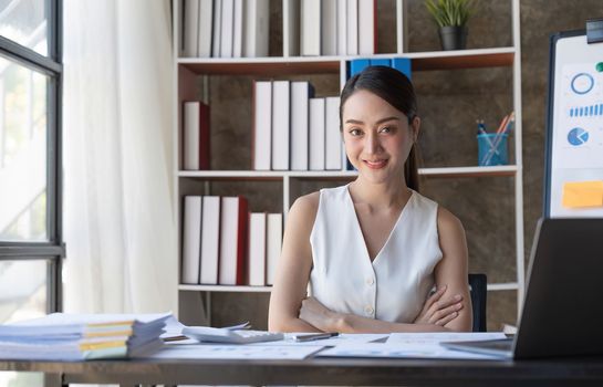 Portrait of successful young businesswoman sitting at her office.